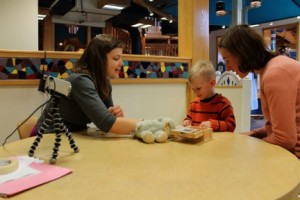 Graduate student from the Early Childhood Cognition Lab, Nadia Chernyak, conducts a study with child participant. Photo by Sciencenter. 