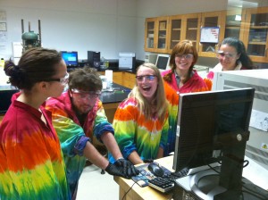 Introductory Chemistry (Chem 125) students learning to use the gas chromatography - mass spectrometer for analyzing toxins in consumer products. Tie-dyed lab coats are signature apparel for the Chem 125 toxicology lab students. Photo: Tim Elgren
